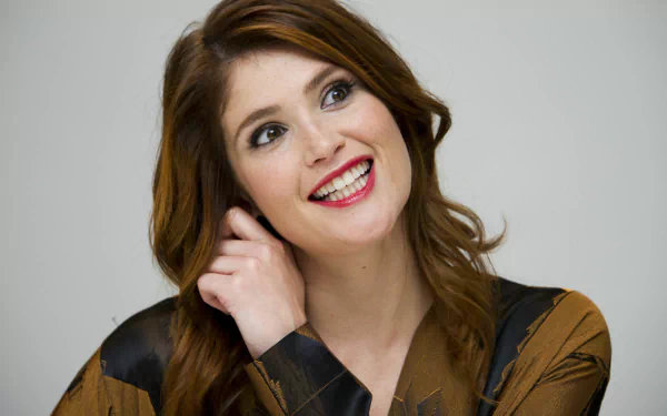 HD desktop wallpaper featuring a close-up of actress and celebrity Gemma Arterton smiling with a light background.