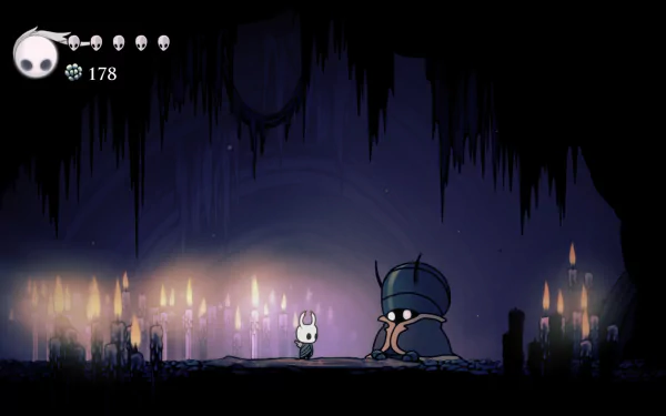 4K Ultra HD PC desktop wallpaper/background of Jiji (Hollow Knight) from the video game Hollow Knight: small white knight faces a cloaked figure amid a candlelit cavern.