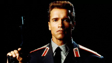 HD desktop wallpaper of Arnold Schwarzenegger in his Red Heat movie role, dressed in a dark uniform and holding a gun against a black background.