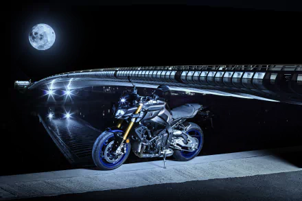 A Yamaha MT-10 motorcycle parked under a bridge at night with a full moon in the background, captured in stunning 4K Ultra HD quality.