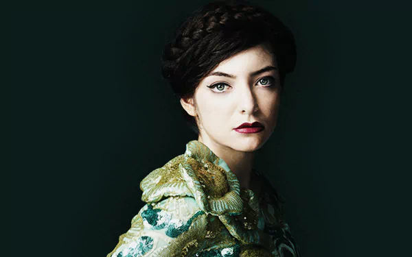 Portrait of singer Lorde with dark lipstick and braided hair, set against a dark background, designed as an HD PC desktop wallpaper.