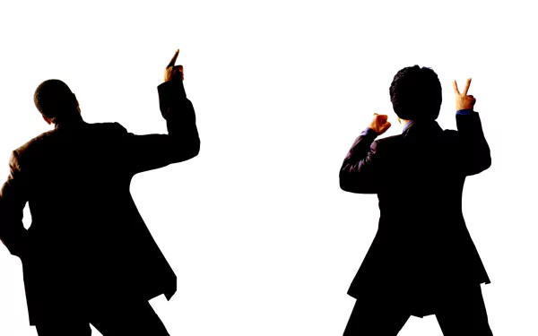 A dynamic HD desktop wallpaper featuring silhouettes of Chris Tucker and Jackie Chan from the movie Rush Hour 2, striking playful poses against a white background.