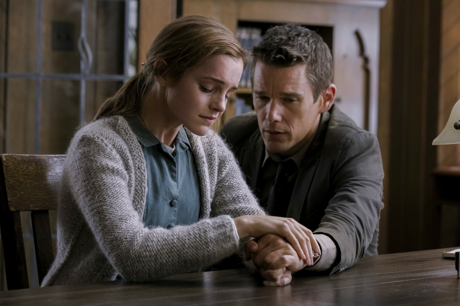 HD desktop wallpaper featuring Emma Watson and Ethan Hawke in a tense scene from the movie Regression.