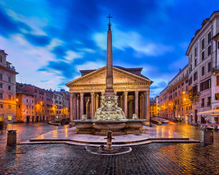HD desktop wallpaper showcasing the iconic Pantheon with its obelisk and fountain in the heart of Rome, Italy, surrounded by historic city buildings under a vibrant sky.