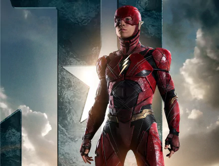 HD desktop wallpaper featuring Ezra Miller as Flash from the movie Justice League, standing heroically against a dramatic sky background with a large emblem behind.