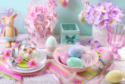 HD wallpaper displaying a pastel-colored Easter still life with decorated eggs, flowers, a bunny figurine, and festive holiday decorations.