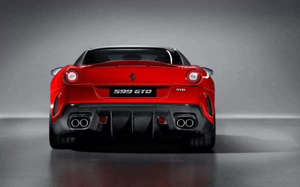 Rear view of a red Ferrari 599 GTO grand tourer vehicle with quad exhausts and aggressive diffuser, presented as an HD PC desktop wallpaper background.