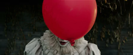 HD PC desktop wallpaper from the movie It (2017) featuring Pennywise the clown partially obscured by a large red balloon.