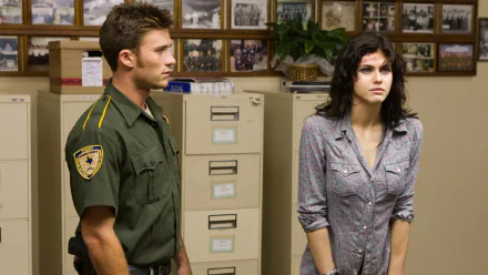 Scott Eastwood and Alexandra Daddario in a scene from Texas Chainsaw 3D, standing in an office space with file cabinets and framed photos. HD desktop wallpaper and background.
