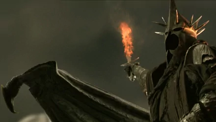 A dramatic HD wallpaper from The Lord of the Rings: The Return of the King, featuring a menacing dark figure holding a flaming sword against a stormy backdrop.