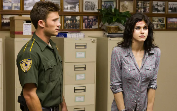 Scott Eastwood and Alexandra Daddario in a scene from Texas Chainsaw 3D, standing in an office space with file cabinets and framed photos. HD desktop wallpaper and background.