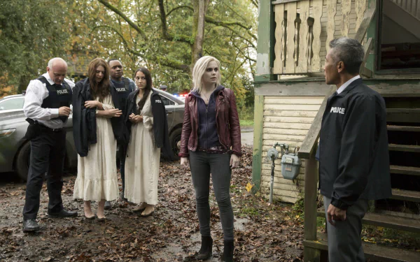 Liv Moore from the TV show iZombie stands in a wooded yard with three women in white dresses and police officers — 2K Quad HD PC desktop wallpaper background.