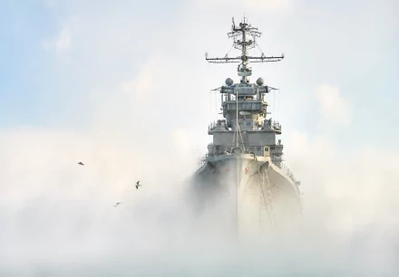 Soviet cruiser Mikhail Kutuzov warship of the Russian Navy emerging through thick fog, captured in an HD desktop wallpaper background.