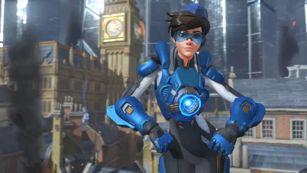 HD desktop wallpaper featuring Tracer from the video game Overwatch, set against an urban backdrop with a clock tower.