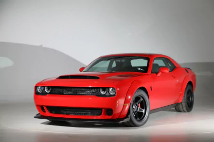 Red Dodge Challenger SRT Demon muscle car in a studio shot, HD PC desktop wallpaper/background showcasing its aggressive front end and wide stance.