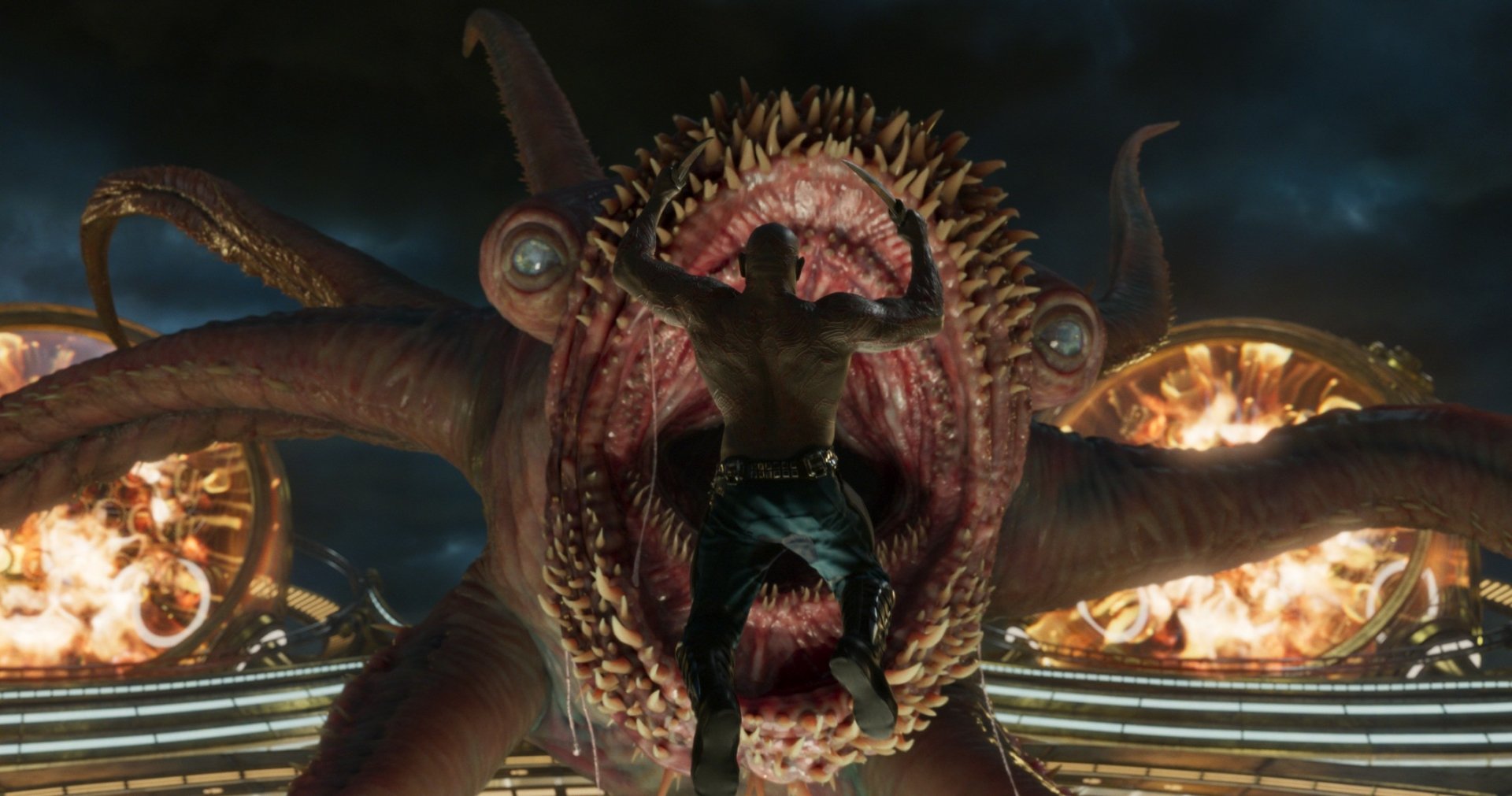 Drax The Destroyer, played by Dave Bautista, confronts a monstrous creature in a dramatic scene from Guardians of the Galaxy Vol. 2, featured in an HD PC desktop wallpaper.