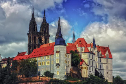 Albrechtsburg Castle in Germany exemplifies stunning architecture, featuring intricate towers and colorful rooftops set against a dramatic sky, captured in vibrant 4K Ultra HD.