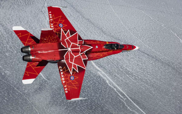 A red McDonnell Douglas CF-18 Hornet jet fighter with white maple leaf design flies over a patterned icy surface, captured in 4K Ultra HD detail.