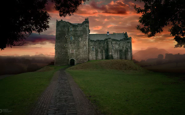 Abandoned old castle under a dramatic sunset sky, set on a grassy hill with a stone path leading toward it, captured in HD for a PC desktop wallpaper background.