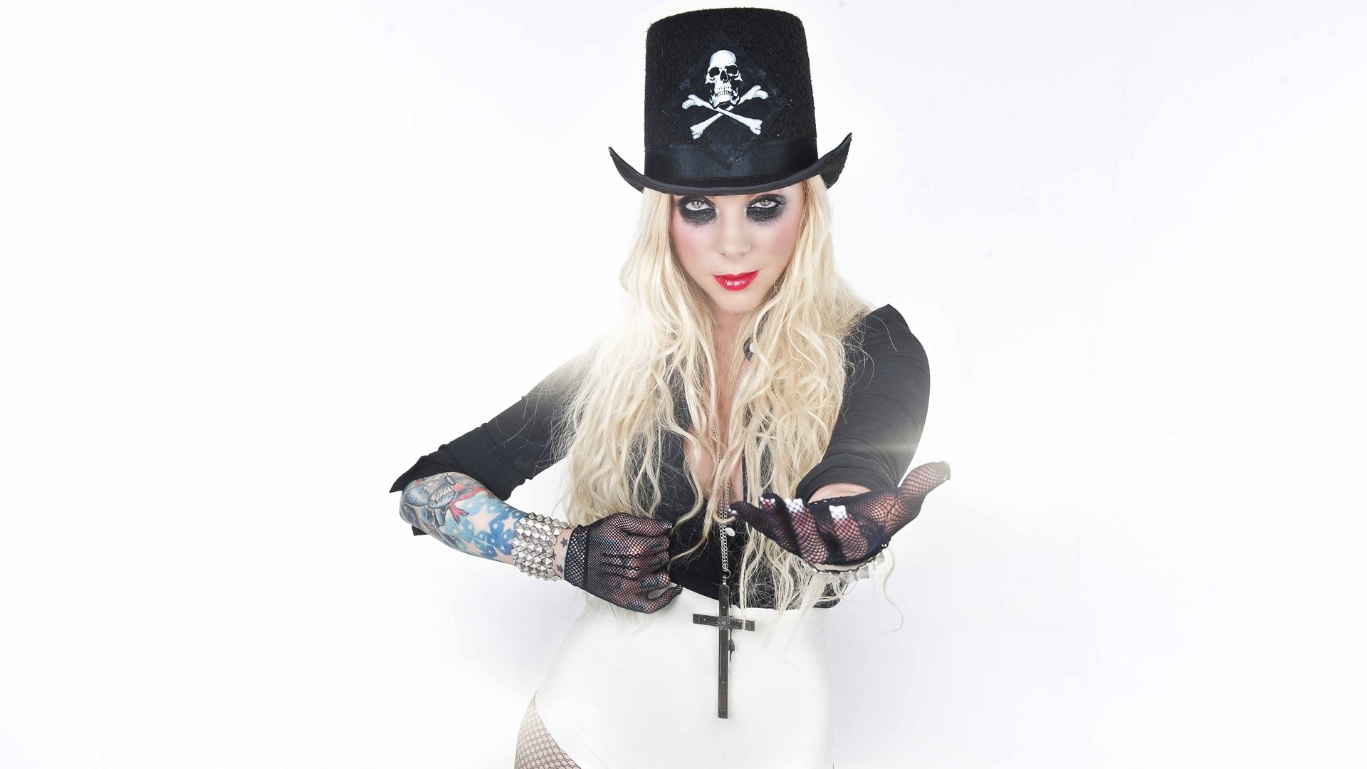 HD PC desktop wallpaper: heavy metal, In This Moment–themed singer in a skull top hat, long blonde hair, cross pendant, tattooed arm and gloved hands on a white background.
