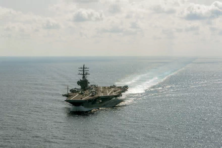 4K Ultra HD desktop wallpaper of the U.S. Navy aircraft carrier USS Ronald Reagan (CVN-76) steaming at sea, flight deck and wake visible.