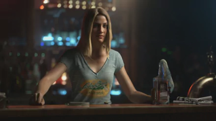 HD PC desktop wallpaper featuring a female character from the video game Far Cry 5, standing behind a bar with a bottle and glass in a dimly lit setting.