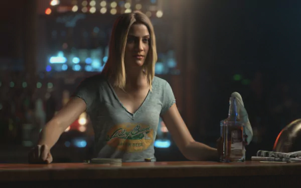 HD PC desktop wallpaper featuring a female character from the video game Far Cry 5, standing behind a bar with a bottle and glass in a dimly lit setting.
