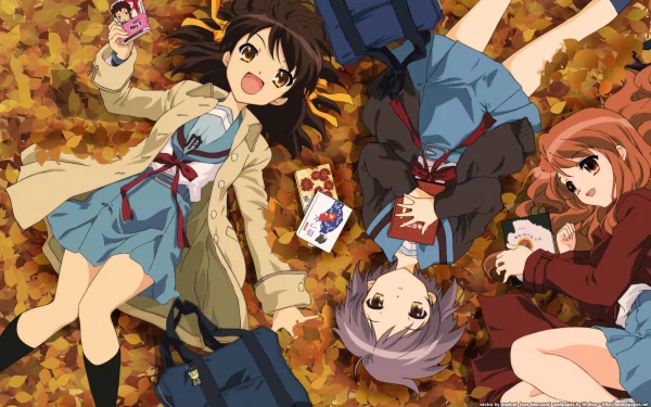 Three characters from The Melancholy of Haruhi Suzumiya relax on autumn leaves. Haruhi, Mikuru, and Yuki wear school uniforms, enjoying a cheerful moment together, surrounded by backpacks and snacks.