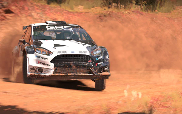 HD desktop wallpaper featuring a rally car from Dirt 4 kicking up dust on an off-road track.