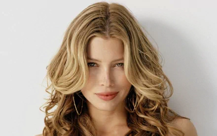 High-definition desktop wallpaper featuring celebrity Jessica Biel with soft, wavy hair and a captivating expression, set against a simple background.
