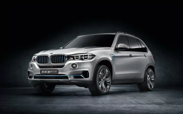 Silver BMW X5 SUV, front three-quarter view on a dark textured backdrop — HD PC desktop wallpaper showcasing the car and vehicle.
