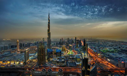 A stunning HD wallpaper of Dubai's cityscape featuring illuminated skyscrapers, including the iconic Burj Khalifa, against a twilight horizon in the United Arab Emirates.
