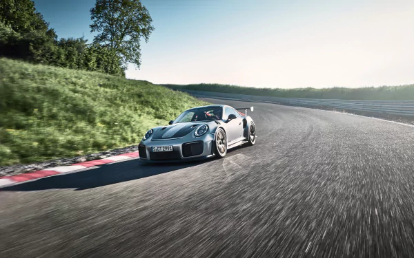 Silver Porsche 911 GT2 speeding on a curving racetrack, captured as a 4K Ultra HD PC desktop wallpaper.