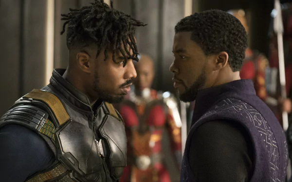 Michael B. Jordan as Erik Killmonger and Chadwick Boseman in a tense face-off from the movie Black Panther. This HD desktop wallpaper captures an iconic scene from the Marvel film.