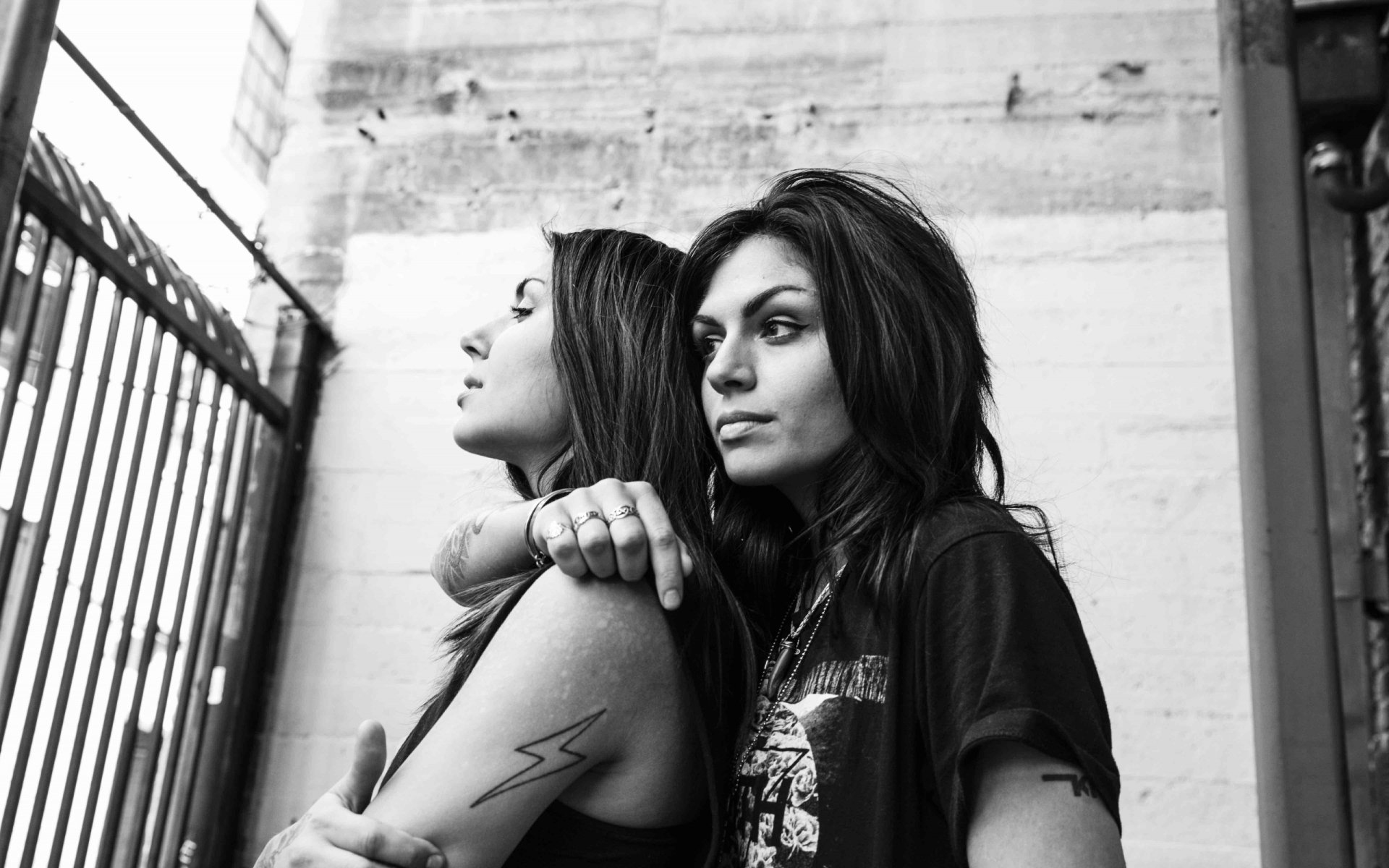 Black and white HD PC desktop wallpaper featuring the music duo Krewella posing against an urban wall, embodying a moody, edgy vibe.
