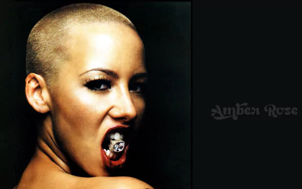 HD desktop wallpaper featuring a person with a shaved head biting a ring, against a dark background with Amber Rose text.