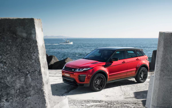 A red Range Rover Evoque SUV parked near the coast, captured in sharp 4K Ultra HD as a PC desktop wallpaper and background.