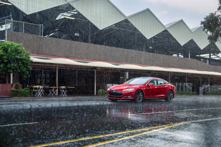 Red Tesla Model S parked on a wet street under heavy rain, with a modern building in the background. 4K Ultra HD PC desktop wallpaper showcasing the Tesla vehicle.