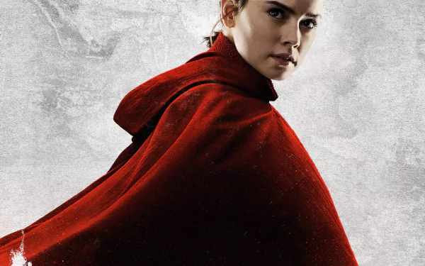 HD desktop wallpaper featuring Daisy Ridley as Rey from Star Wars: The Last Jedi, dressed in a red cloak, against a textured gray background.