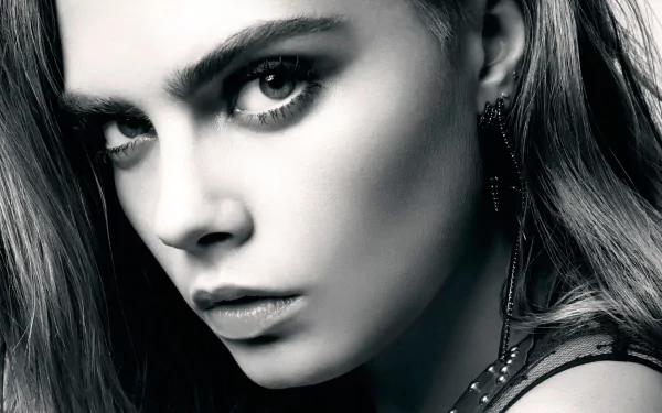 Close-up black-and-white HD desktop wallpaper of celebrity Cara Delevingne with intense gaze and striking features.