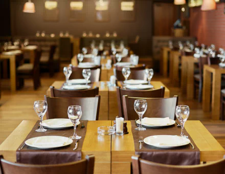 Elegant restaurant interior with set tables and chairs, suitable as an HD desktop wallpaper and background.