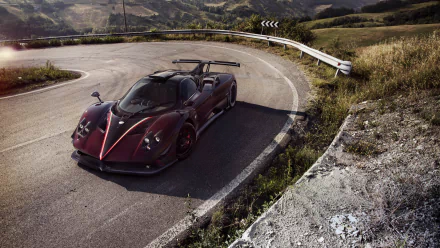 A sleek Pagani Zonda supercar parked on a winding mountain road, captured in stunning 4K Ultra HD for a dynamic PC desktop wallpaper and background.
