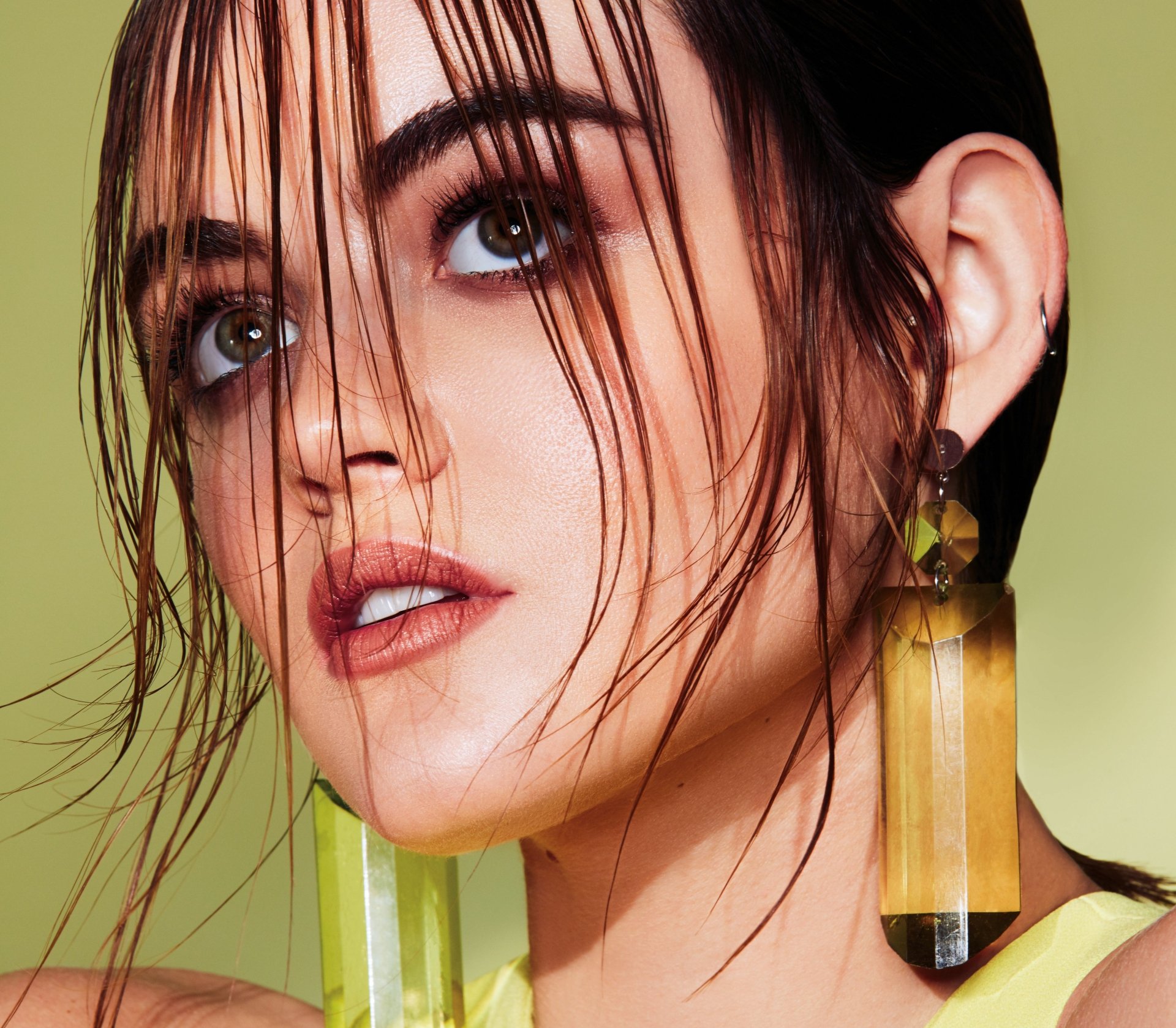 Close-up portrait of American actress Lucy Hale with brunette hair, wearing earrings, displayed in 4K Ultra HD for a PC desktop wallpaper.