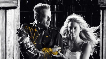 A striking HD wallpaper from the movie Sin City, featuring a dramatic black and white scene with a man and a woman, accented by vibrant yellow splashes, capturing the film's gritty aesthetic.