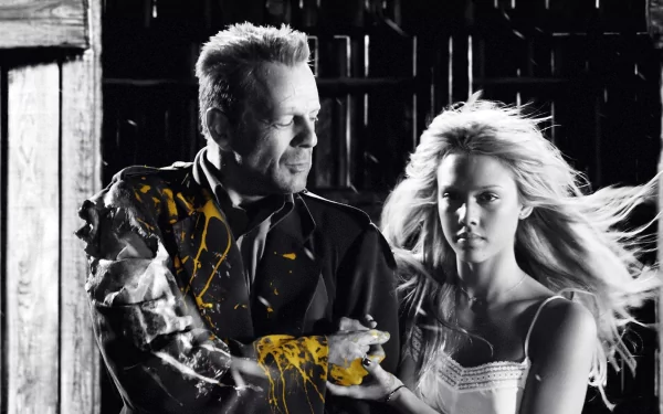 A striking HD wallpaper from the movie Sin City, featuring a dramatic black and white scene with a man and a woman, accented by vibrant yellow splashes, capturing the film's gritty aesthetic.