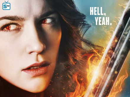 Close-up of the TV show Wynonna Earp heroine with fiery eyes and a glowing gun-blade, intense stare amid embers, 2K Quad HD PC desktop wallpaper/background.