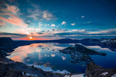 HD desktop wallpaper of Crater Lake at sunset, showing a stunning reflection of the sky on the calm lake waters, with an island in the center providing a picturesque natural scene.