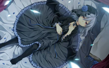 HD PC desktop wallpaper: Remilia Scarlet (Touhou) in a gothic frilled dress, silver-blue hair and red eyes, reclining on a bed surrounded by glowing petals.
