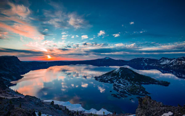 HD desktop wallpaper of Crater Lake at sunset, showing a stunning reflection of the sky on the calm lake waters, with an island in the center providing a picturesque natural scene.