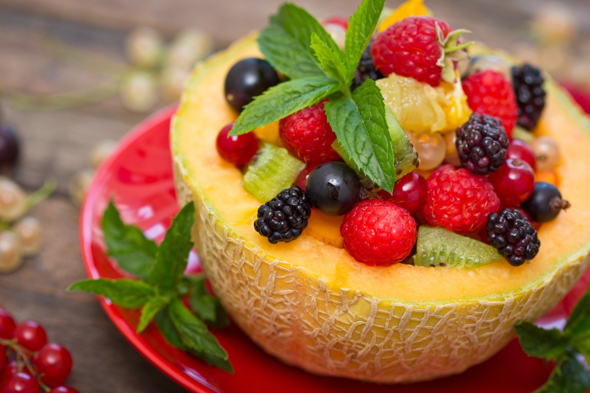 5K Ultra HD PC desktop wallpaper of a halved melon filled with assorted berries and fruit, garnished with fresh mint.